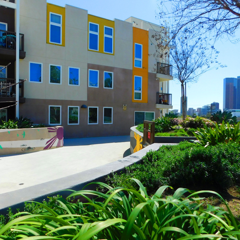 Residential building with a walkway and greenery going around it