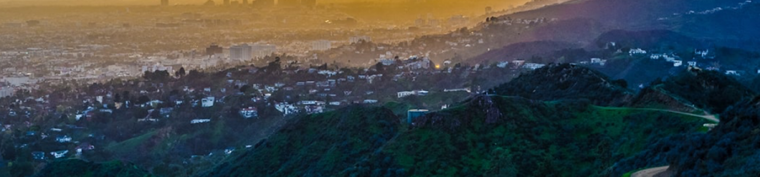 Sun setting over a valley of homes.