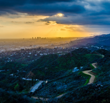 Wide view of an inhabited valley as the sun sets.